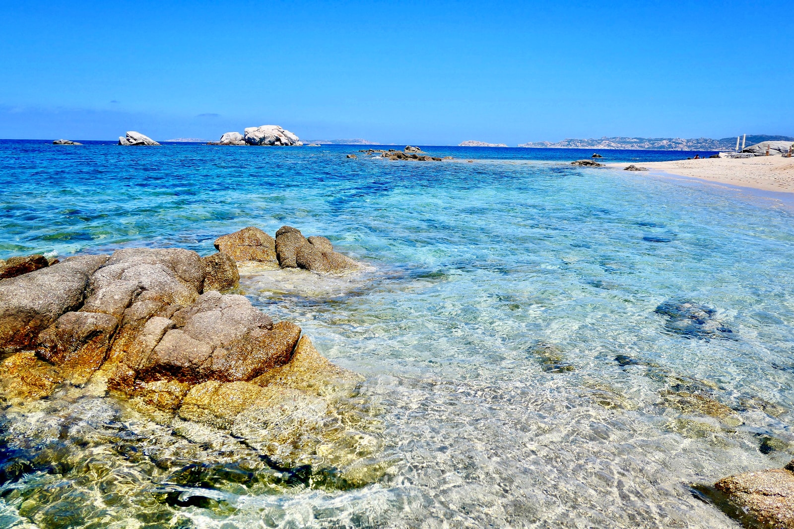 brown rocks on blue sea under blue sky during daytime